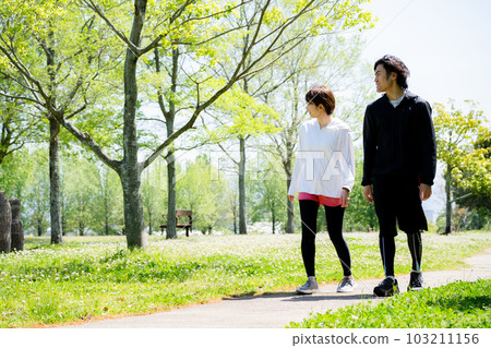 young couple walking in the park young couple walking in the park 103211156