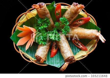 Traditional fried vietnamese spring rolls with shrimps and pork, rice paper on black background Traditional fried vietnamese spring rolls with shrimps and pork, rice paper on black background 103211648