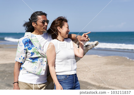 Middle senior couple looking at the sea side by side Middle senior couple looking at the sea side by side 103211837