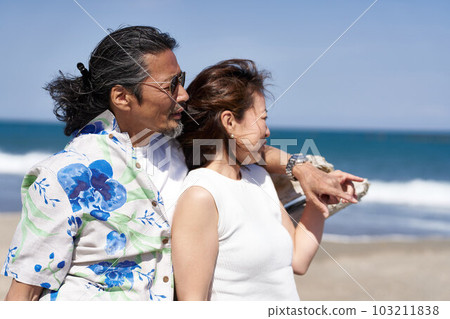 Middle senior couple looking at the sea side by side 103211838