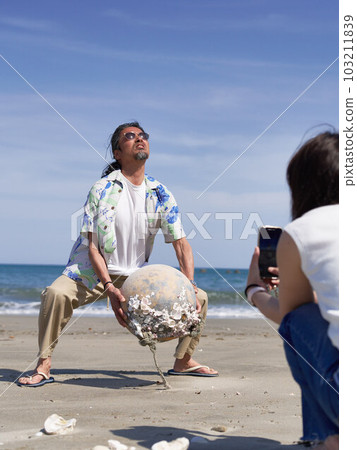 Middle-senior man playing at the beach Middle-senior man playing at the beach 103211839