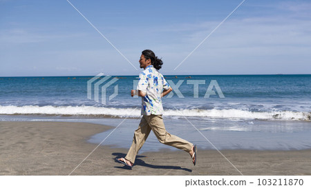 Middle senior man running on the beach under the blue sky Middle senior man running on the beach under the blue sky 103211870