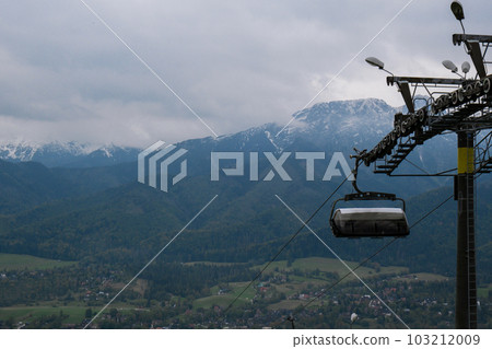 Ski Lift snowy mountain autumn forest with chair lift At The Ski Resort in Zakopane Poland. Holidays Vacation sport and outdoor activities tourism cable car empty seat grass field in green forest on 103212009