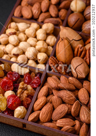 Mix of roasted macadamia nuts, cashews, pecans, almonds, raisins and dry berries 103212937
