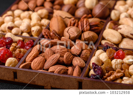 Mix of roasted macadamia nuts, cashews, pecans, almonds, raisins and dry berries 103212938