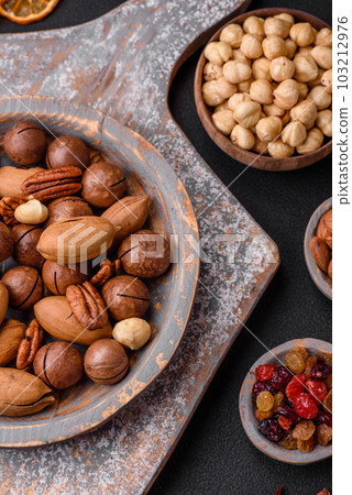 Mix of roasted macadamia nuts, cashews, pecans, almonds, raisins and dry berries 103212976