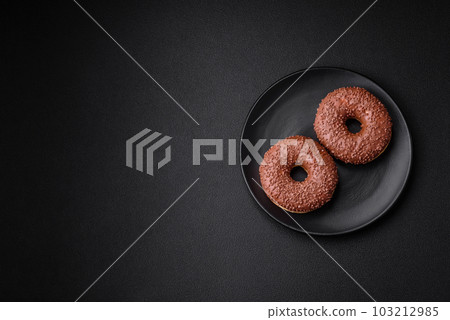 Delicious chocolate glazed donut sprinkled with chocolate chips 103212985