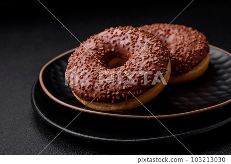 Delicious chocolate glazed donut sprinkled with chocolate chips 103213030