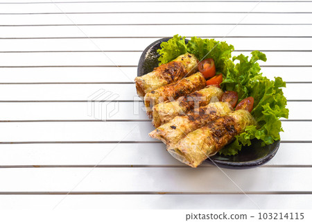 Traditional fried vietnamese spring rolls with pork, rice paper on black background side view 103214115