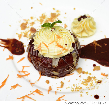 Carrot chocolate cake on plate and black background Carrot chocolate cake on plate and black background 103214124