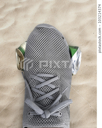 human foot stomp cans flat on the sand, beach, sea 103214374