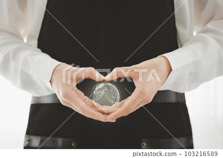 closeup woman heart shape hand with globe icon inside closeup woman heart shape hand with globe icon inside 103216589