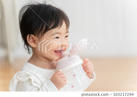 9 month old baby drinking from mug 103217294