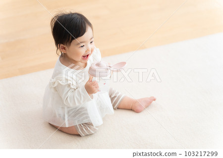 9 month old baby drinking from mug 103217299