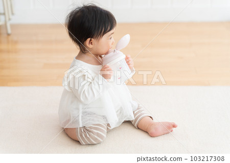 9 month old baby drinking from mug 9 month old baby drinking from mug 103217308