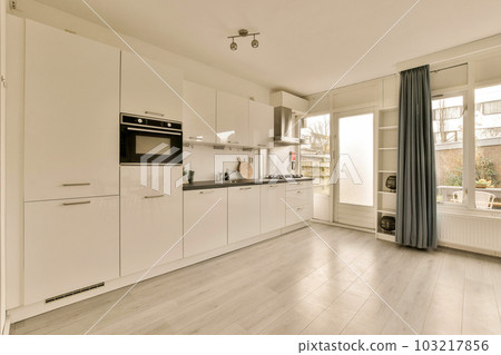 a kitchen with white cupboards and appliances on the counter top in front of the oven, sink and dishwasher a kitchen with white cupboards and appliances on the counter top in front of the oven, sink and dishwasher 103217856