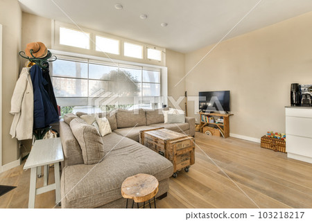 a living room with wood flooring and large windows looking out onto the street in the photo is taken from inside a living room with wood flooring and large windows looking out onto the street in the photo is taken from inside 103218217