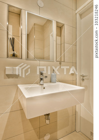 a bathroom with a white sink and mirror above the sink is an image of a toilet in front of it 103218246