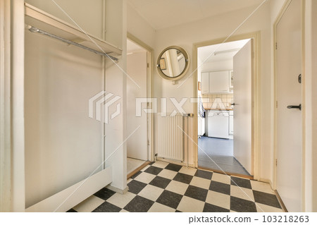 an empty room with a black and white checkered floor, mirror on the wall and door to the left an empty room with a black and white checkered floor, mirror on the wall and door to the left 103218263