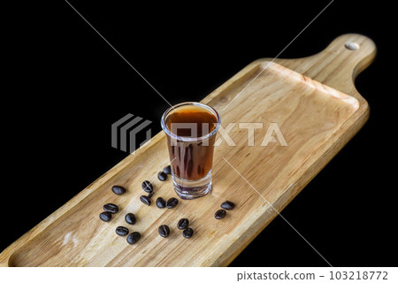 Alcohol shot made of coffee on wooden board with coffee beans with copy space  103218772