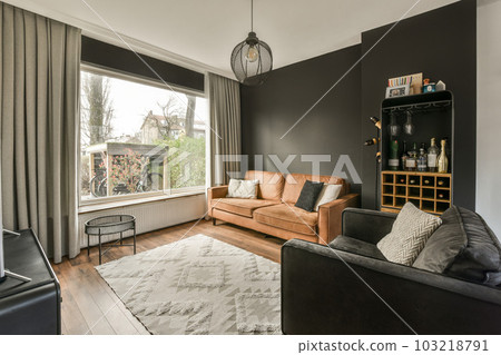a living room with two couches and a coffee table in front of the window looking out onto the street 103218791