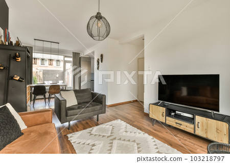 a living room with couches and a television set on the wall in front of the flat screen tv that is mounted above the a living room with couches and a television set on the wall in front of the flat screen tv that is mounted above the 103218797