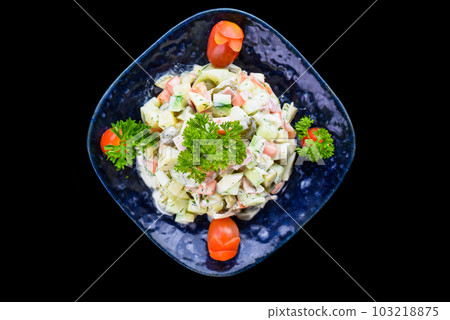 Russian salad olivie on black background top view Russian salad olivie on black background top view 103218875
