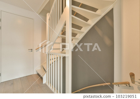 a white staircase in a house with grey walls and hardwood flooring the stairs are made out of wood planks a white staircase in a house with grey walls and hardwood flooring the stairs are made out of wood planks 103219051