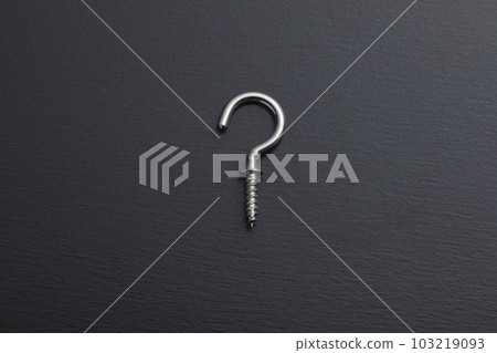 A screw with a hook photographed on a black background 103219093