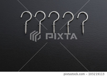 A screw with a hook photographed on a black background A screw with a hook photographed on a black background 103219113