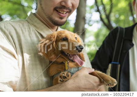 Two men who came to the park with their dog 103220417