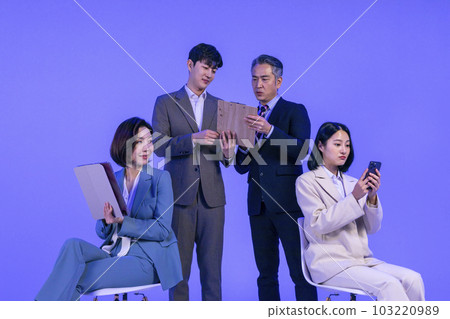 Asian Korean senior, middle aged and young male and female colleagues models in business attire, neon purple studio background, working 103220989