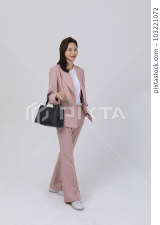 business concept korean young woman, holding a handbag 103221072