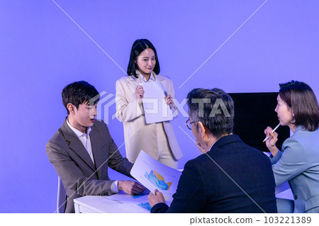 Asian Korean senior, middle aged and young male and female colleagues models in business attire, neon purple studio background, difficult to present 103221389