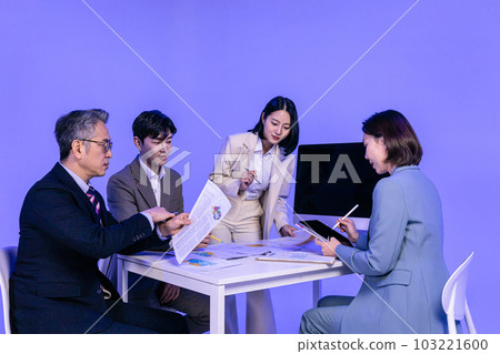 Asian Korean senior, middle aged and young male and female colleagues models in business attire, neon purple studio background, meeting 103221600