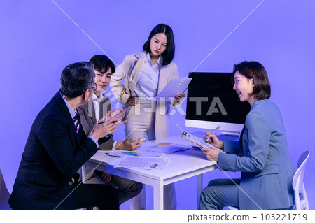 Asian Korean senior, middle aged and young male and female colleagues models in business attire, neon purple studio background, meeting 103221719