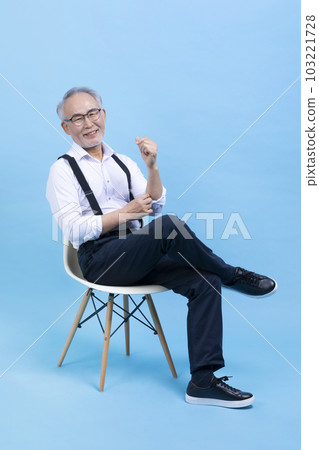 active young senior Korean Asian male sitting on the chair 103221728