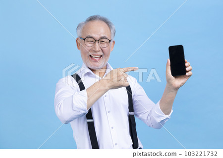 active young senior Korean Asian male holding headset active young senior Korean Asian male holding headset 103221732