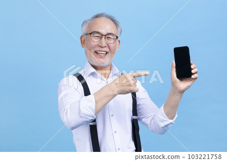 active young senior Korean Asian male holding headset 103221758