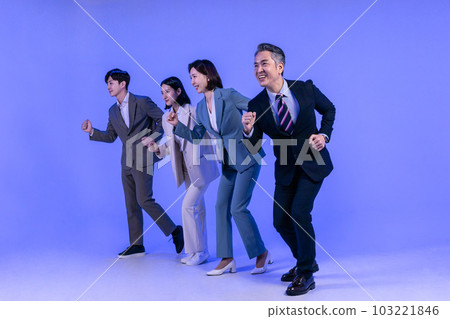 Asian Korean senior, middle aged and young male and female colleagues models in business attire, neon purple studio background, running motion Asian Korean senior, middle aged and young male and female colleagues models in business attire, neon purple studio background, running motion 103221846