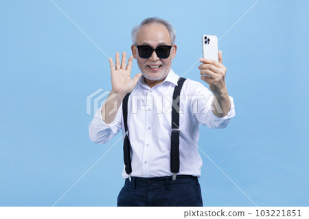 active young senior Korean Asian male on video chat, call 103221851