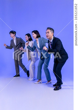 Asian Korean senior, middle aged and young male and female colleagues models in business attire, neon purple studio background, running motion Asian Korean senior, middle aged and young male and female colleagues models in business attire, neon purple studio background, running motion 103221852