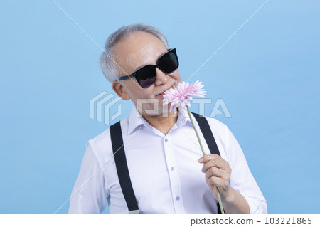 active young senior Korean Asian male holding flowers 103221865