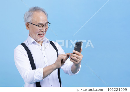 active young senior Korean Asian male looking at smartphone 103221999