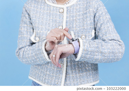 active young senior Korean Asian woman using smart watch 103222000