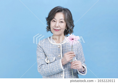 active young senior Korean Asian woman holding flowers active young senior Korean Asian woman holding flowers 103222011