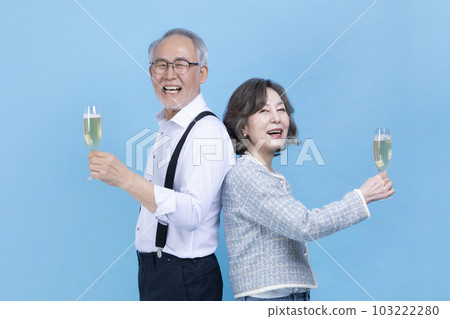 active young senior Korean Asian couple holding champagne glasses active young senior Korean Asian couple holding champagne glasses 103222280