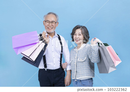 active young senior Korean Asian couple holding shopping bags 103222362
