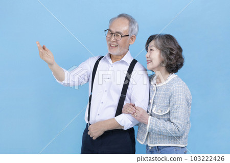 active young senior Korean Asian man and woman standing with arms crossed 103222426