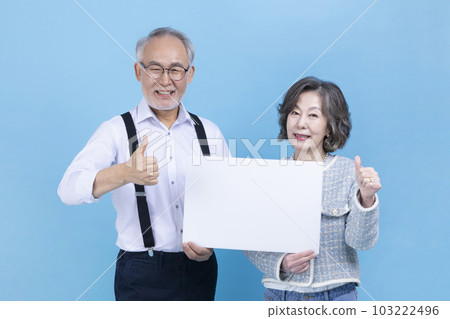 active young senior Korean Asian couple with copyspace board active young senior Korean Asian couple with copyspace board 103222496